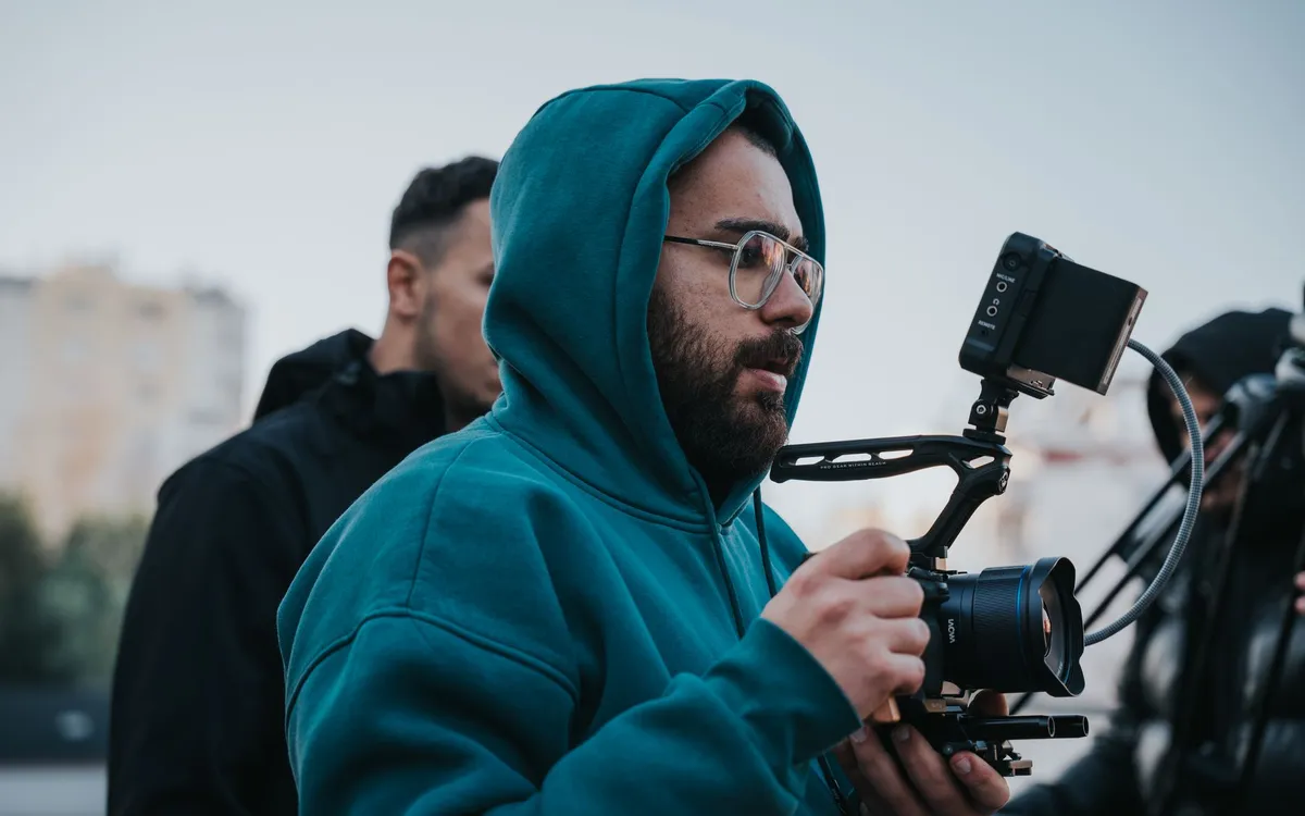 A videographer with a mirrorless camera